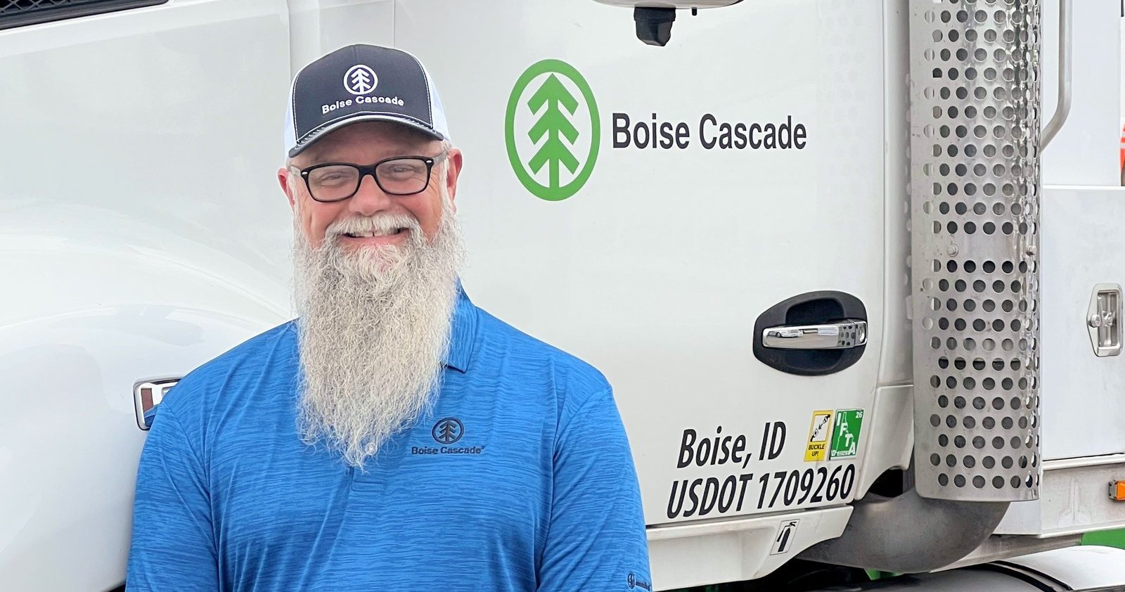 Boise Cascade truck driver standing in front of a Boise Cascade truck